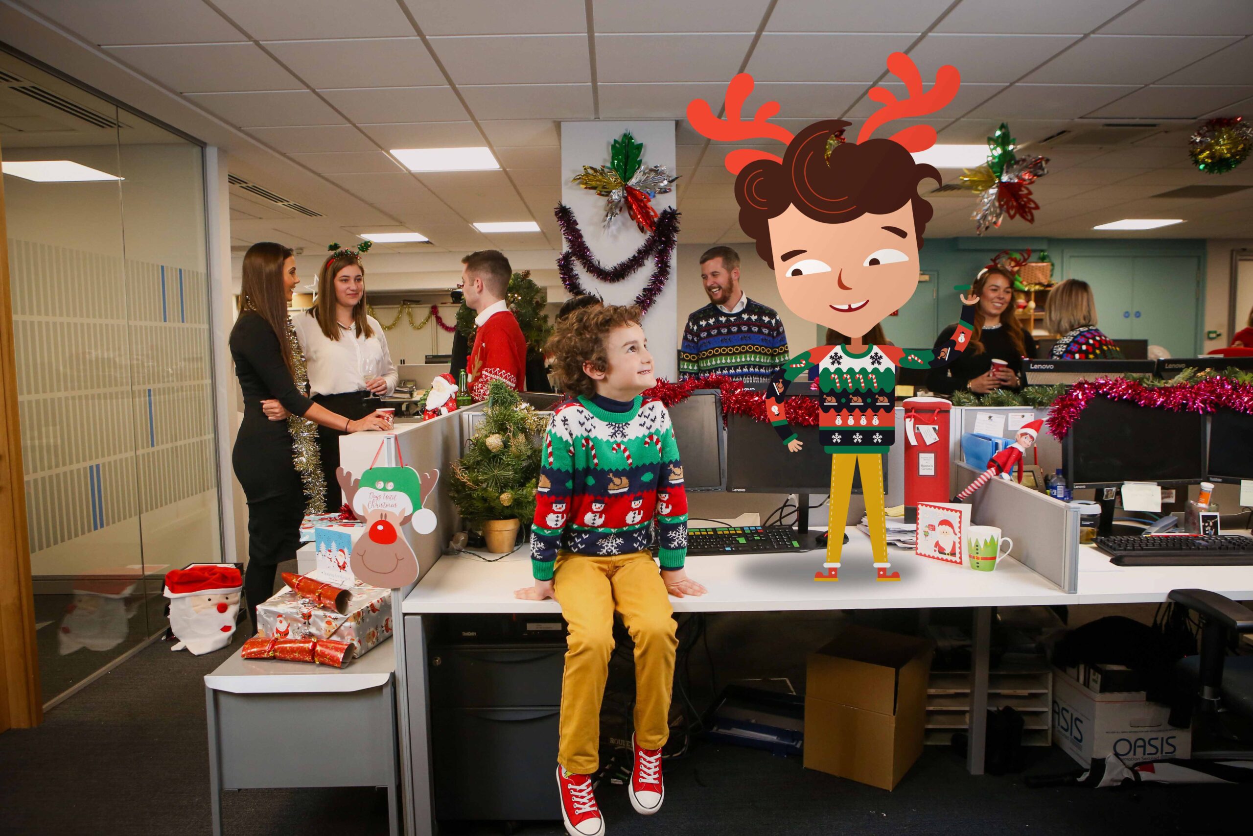 The office is adorned for Christmas, alive with chatter. A child in a festive sweater sits beside an animated character with similar features, embodying the spirit of "Save a Seat for Henry.